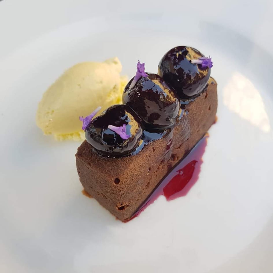 Chocolate brownie, brown butter ice cream, cherries sauce Caesar At The Dolphin Essex Restaurant Braintree